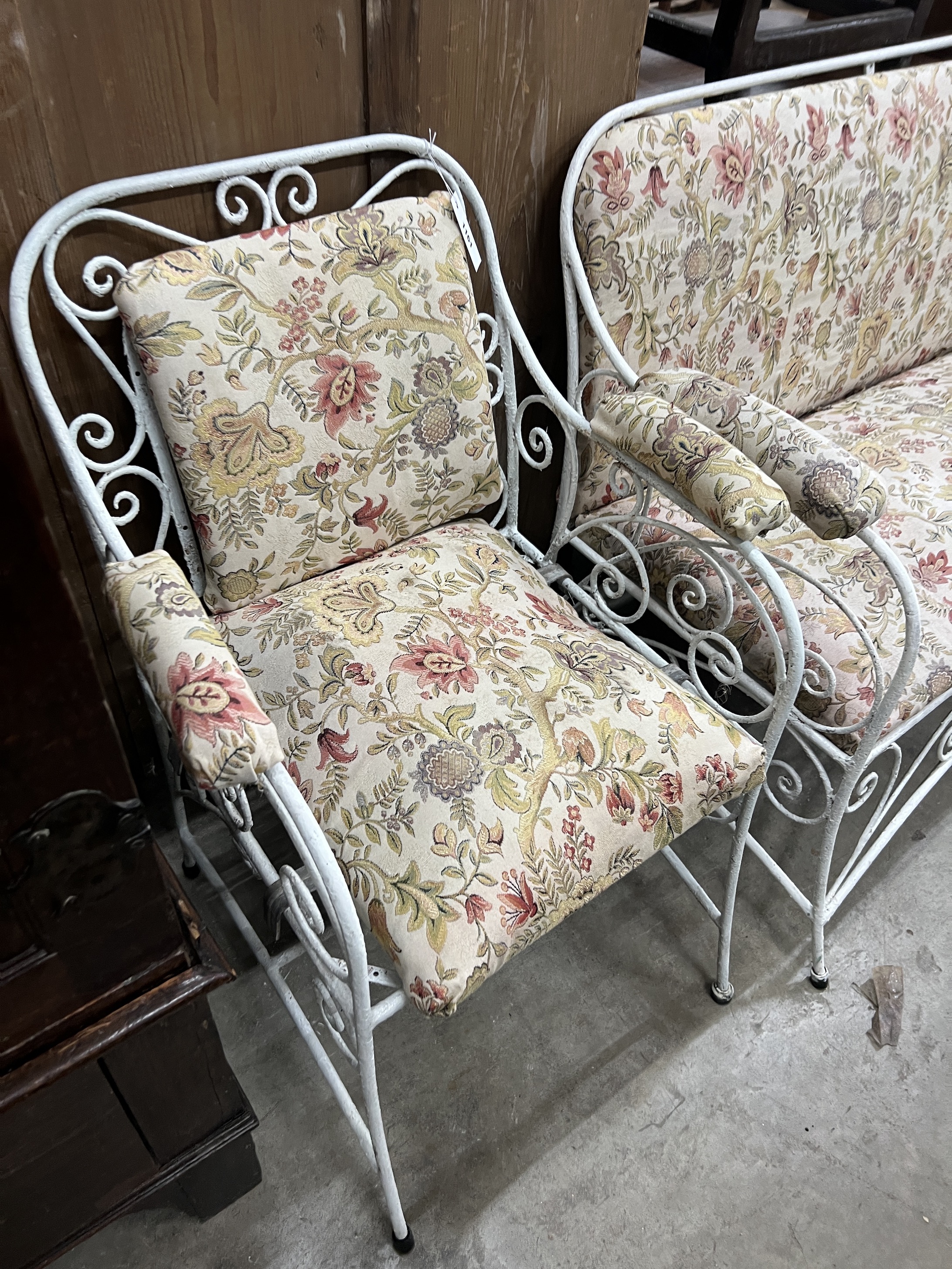A painted wrought iron upholstered three piece suite, settee length 130cm, width 56cm, height 83cm